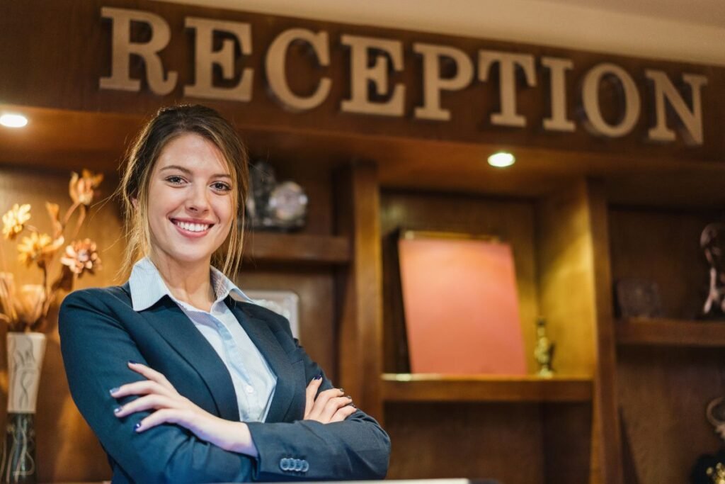receptionist standing in a hotel lobby