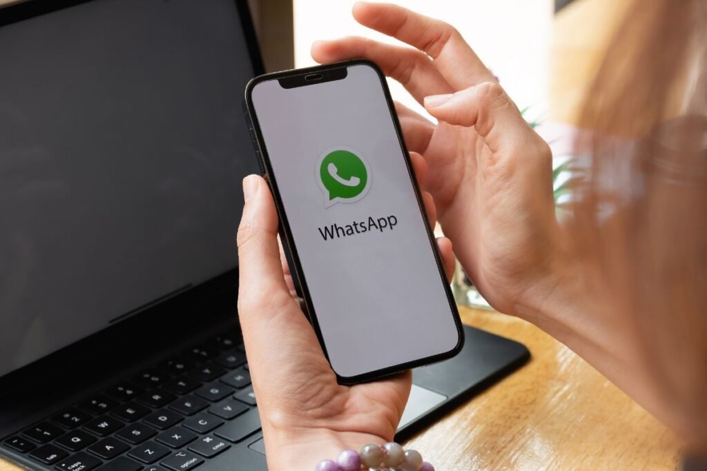 hands login into whatsapp business mobile application on the phone